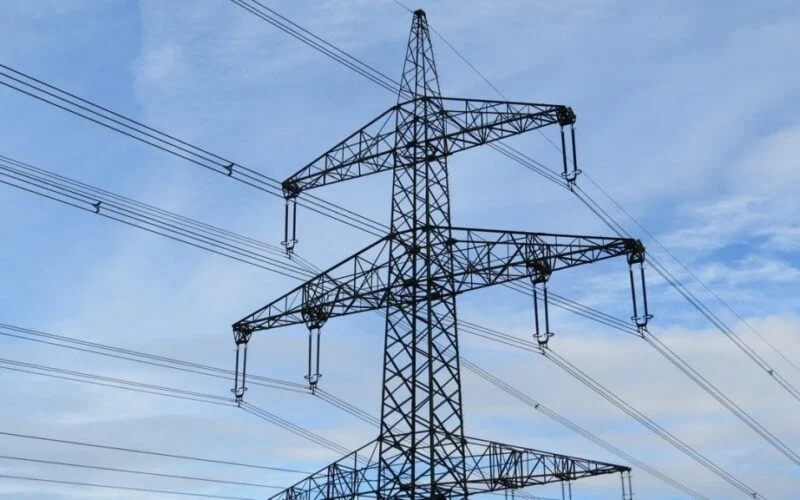 A power transmission tower and lines against the sky