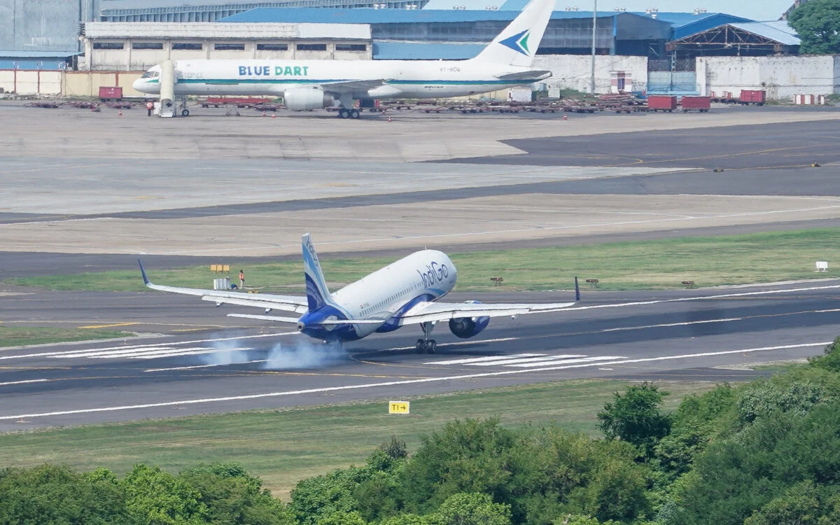 An IndiGo Airbus A320 touching down on a runway at Chennai airport