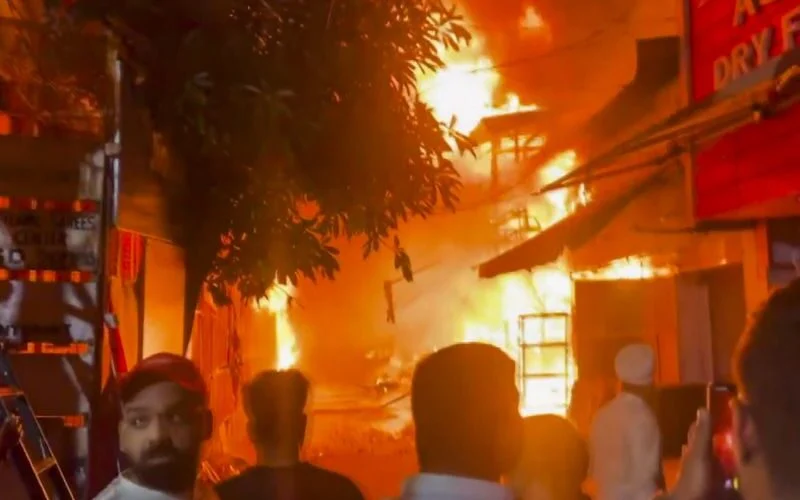 People gather at Shiv Market opposite Jammu Railway Station after the fire
