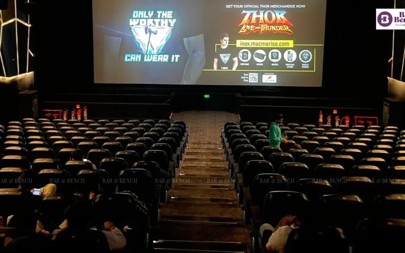 Interior of a cinema theatre with rows of seats facing the screen
