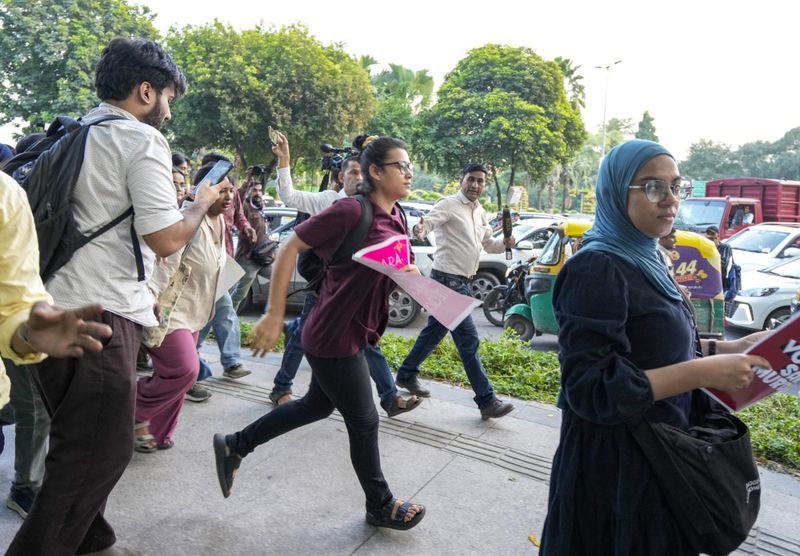 AISA chief Neha Bora with protesters before being detained by Delhi Police